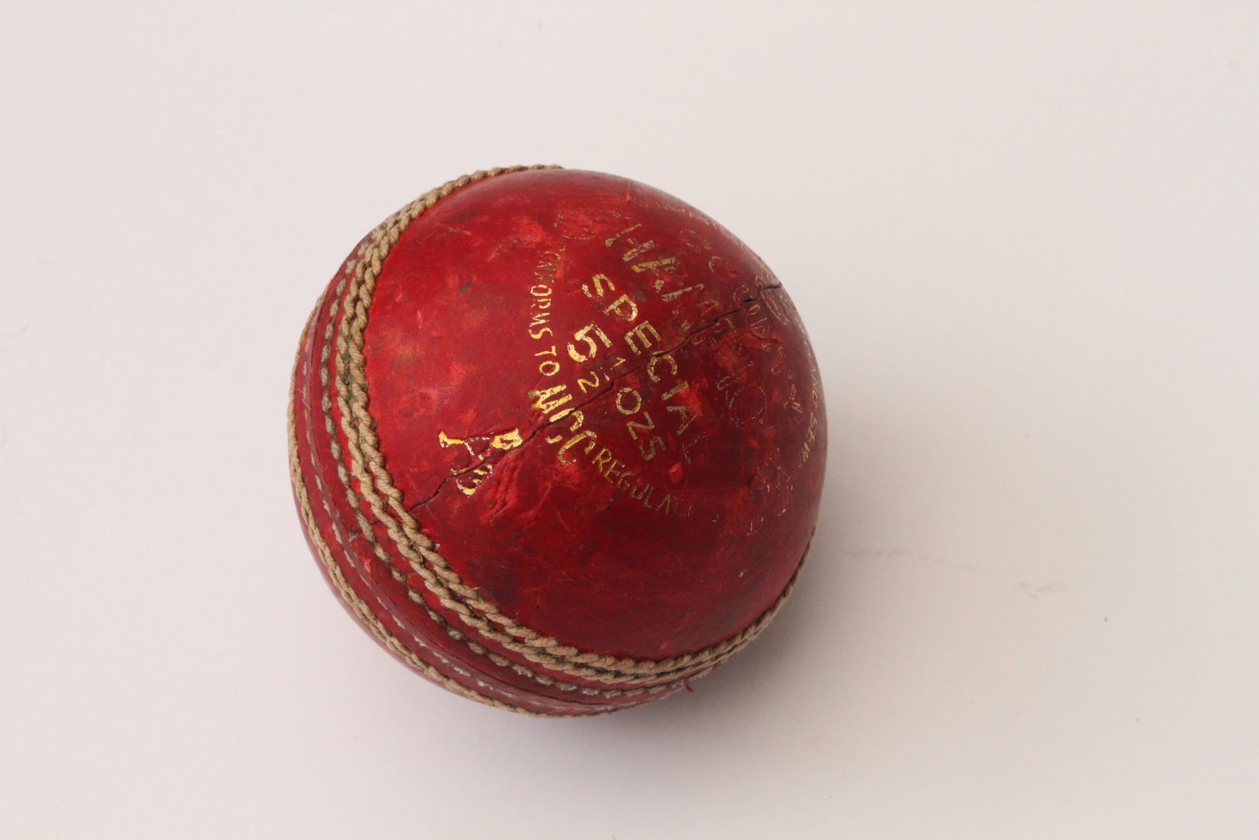 Sovereign 4-Piece Leather Cricket Ball — Alum-tanned four-piece leather ball with a hand-stitched six-row seam and cork-and-wool core.